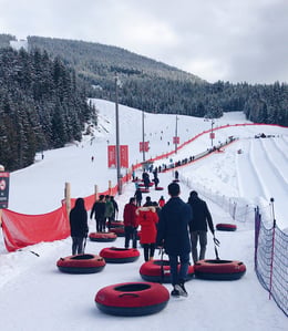 A photo of people snow tubing.