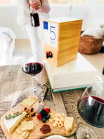 #5 boxt wine by a charcuterie board